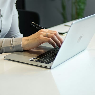 A hand working at a nice desk on a laptop or tablet